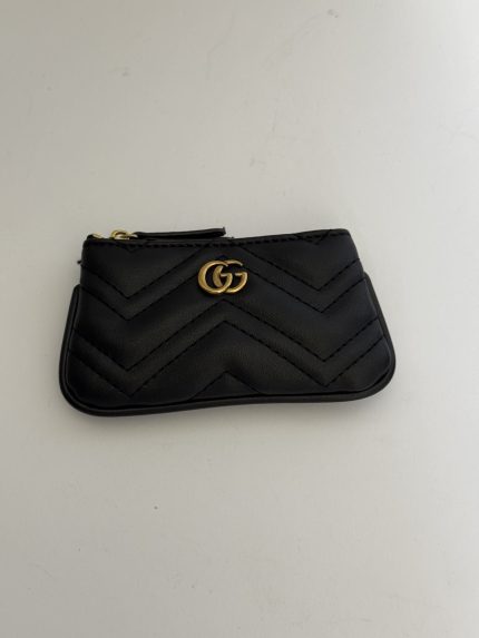 Black Gucci Marmont zip pouch with gold logo detail.