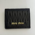 Black Miu Miu Portofol Matelasse wallet with quilted design.
