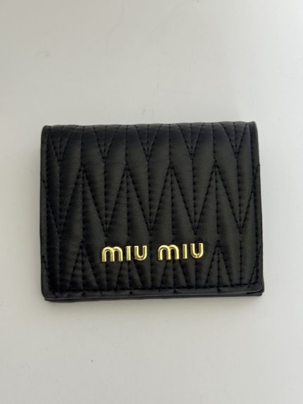 Black Miu Miu Portofol Matelasse wallet with quilted design.