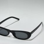 Black women's sunglasses with sleek design on white background.