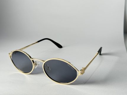 Elegant Gucci women's sunglasses with gold frames and dark lenses.
