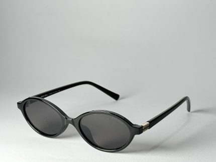 Black Gucci women's sunglasses with round lenses and gold accents.