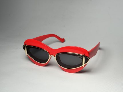 Red Gucci women's sunglasses with black lenses and gold accents.