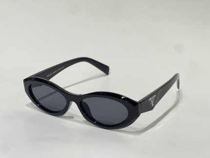 Black Prada women's sunglasses with oval lenses on white background.