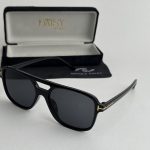 Women's Saint Laurent sunglasses with black frame and case.
