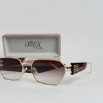 Saint Laurent women's sunglasses with gold frame and gradient lenses.