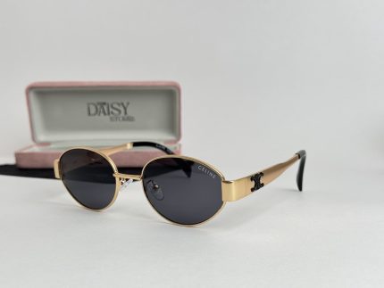 Gold YSL women's sunglasses with black lenses and case.