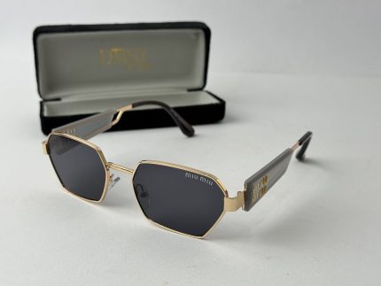 Christian Dior women's sunglasses with black lenses and gold frame.
