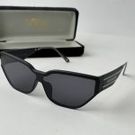 Tom Ford women's sunglasses with black frame and case.