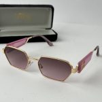Pink Tom Ford women's sunglasses with gold frame and case.