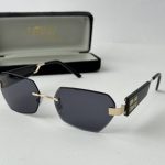 Elegant YSL women's sunglasses with black lenses and gold accents.