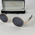Round Gucci sunglasses for women with gold frame.