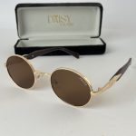Elegant Celine women's sunglasses with gold frames and brown lenses.