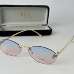Elegant Saint Laurent women's sunglasses with gradient lenses and gold frame.