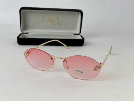 Pink Gucci women's sunglasses with gold frame and case.