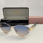 Gucci women's sunglasses with gradient lenses and gold accents.