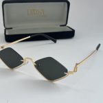 Elegant Gucci women's sunglasses with gold frame and black lenses.