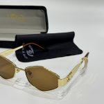 Gold Gucci women's sunglasses with brown lenses and case.