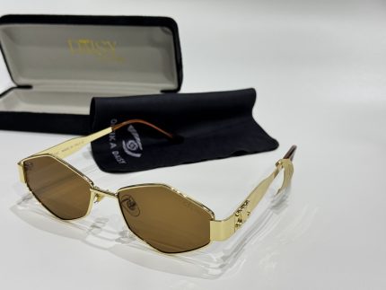 Gold Gucci women's sunglasses with brown lenses and case.