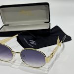 Loewe women's sunglasses with case and cloth, elegant gold frame.