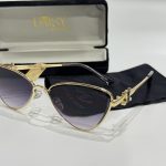 Stylish Prada women's sunglasses with gold frame and black case.