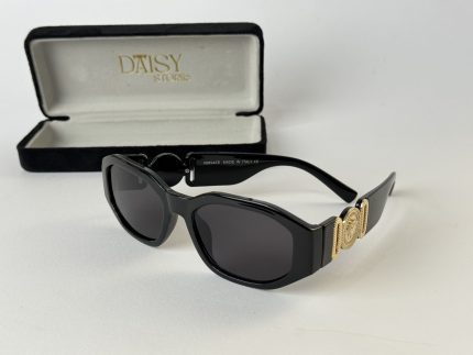 Prada women's sunglasses with black frames and gold accents.