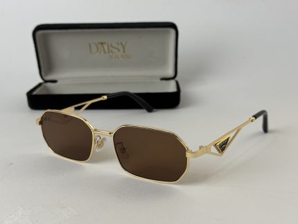 Miu Miu women's sunglasses with gold frame and brown lenses.