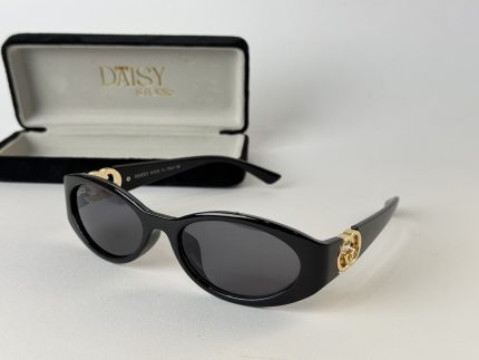 Black Prada women's sunglasses with gold accents and case.