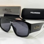 Black Versace sunglasses with branded cases in background.