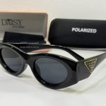 Prada women's sunglasses, elegant black design with protective polarized lenses.