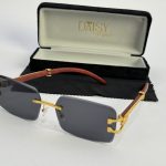 Men's sunglasses with gold accents and wooden arms in case.