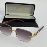 Men's sunglasses with gold accents and gradient lenses in case.