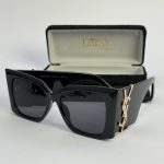 YSL women's sunglasses, black frame, gold logo, with case.