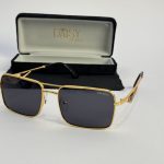 Prada women's sunglasses with gold frame and black lenses, case included.