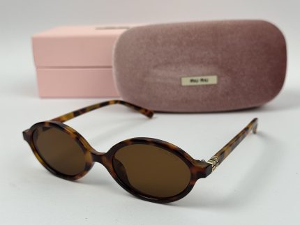 Miu Miu women's sunglasses with case and box displayed.