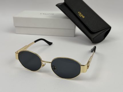 Celine women's sunglasses with gold frame and black lenses.