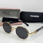 Miu Miu women's sunglasses with gold frame and polarized lenses.