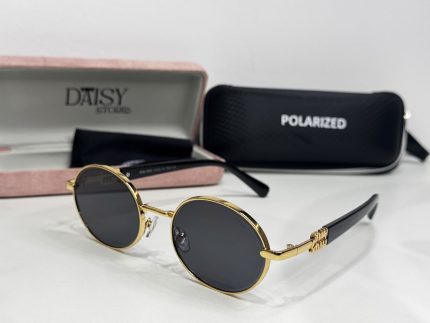 Miu Miu women's sunglasses with gold frame and polarized lenses.