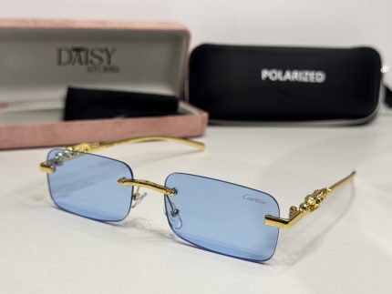 Elegant Cartier women's sunglasses with blue lenses and gold accents.