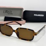 Miu Miu women's sunglasses with tortoiseshell frame and polarized lenses.