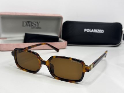 Miu Miu women's sunglasses with tortoiseshell frame and polarized lenses.