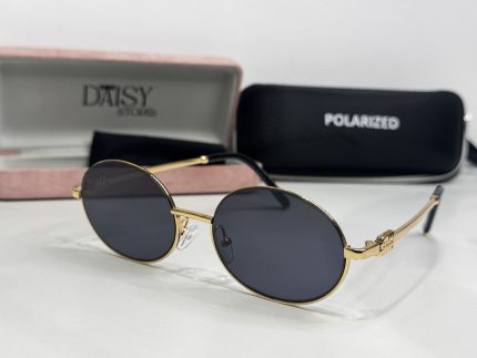 Women's sunglasses with gold frame and polarized lenses.