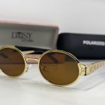 Gucci women's sunglasses with gold frames and brown lenses.