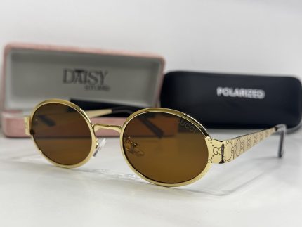 Gucci women's sunglasses with gold frames and brown lenses.