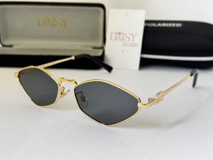 Miu Miu women's sunglasses with gold frame and black lenses.