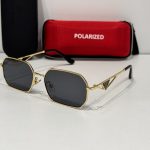 Prada women's sunglasses with gold frame and polarized lenses.