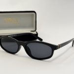 Black Miu Miu women's sunglasses with case, stylish and elegant design.