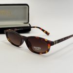 Miu Miu women's sunglasses with tortoiseshell frame and branded case.