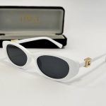 White Gucci women's sunglasses with gold accents and case.