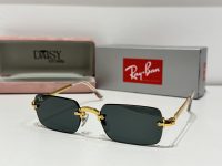 Ray-Ban sunglasses with gold frame and dark lenses displayed.